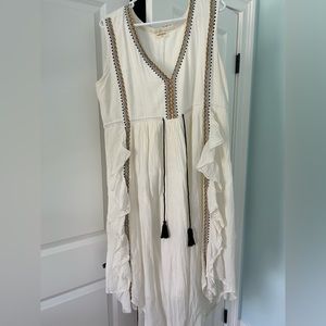 Cream high-low maxi dress with gold and black embroidery.